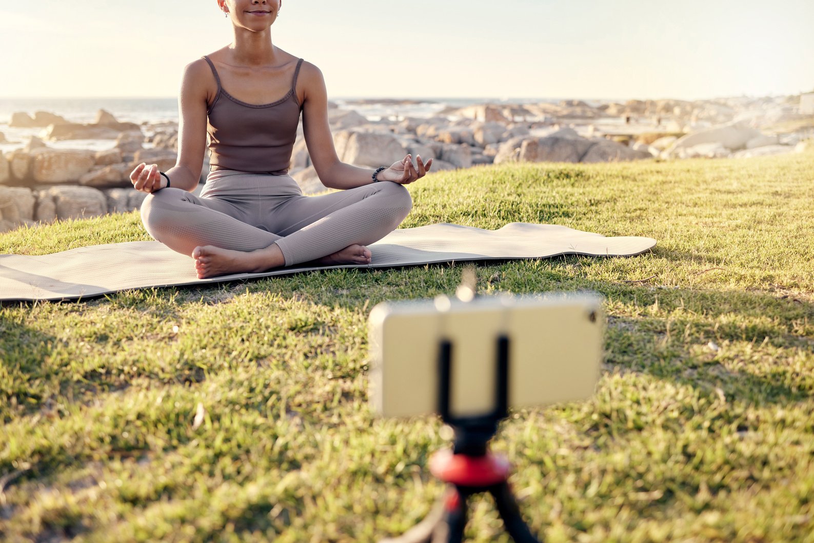 Yoga, Meditation and Live Streaming Woman in Nature on Smartphone for Peace, Healing and Mindfulness Content Creation on Social Media. Influencer or Fitness Content Creator Meditate Outdoor on Video